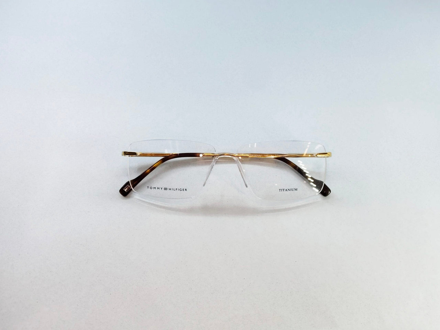 Tommy Hilfiger Eyeglasses Tommy Hilfiger Rimless Frame for Men & Women 213454
