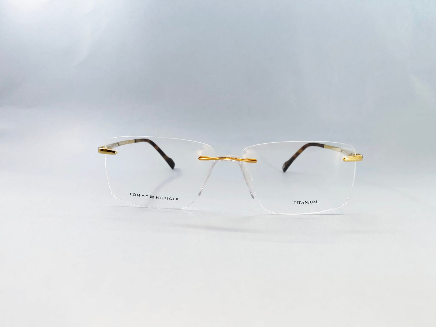 Tommy Hilfiger Eyeglasses Tommy Hilfiger Rimless Frame for Men & Women 213454